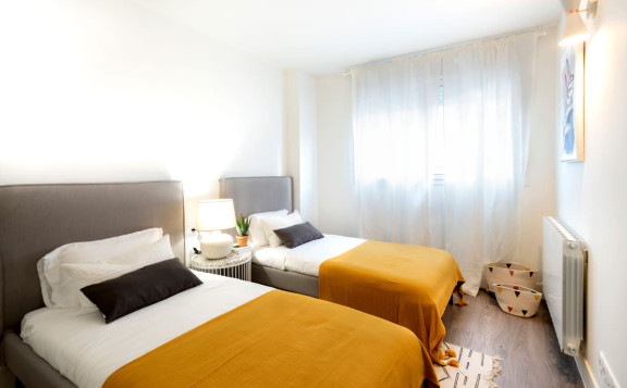 Dormitorio secundario con dos camas individuales en Essència de Sabadell